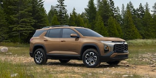 2026 Chevrolet Colorado Trail Boss Midnight Edition shown in black, featured in a rural setting in a 3/4 front passenger-side view while off-roading.