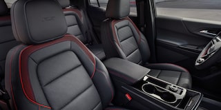 2026 Chevrolet Colorado Trail Boss Midnight Edition shown in black, featured in a rural setting in a 3/4 front passenger-side view while off-roading.