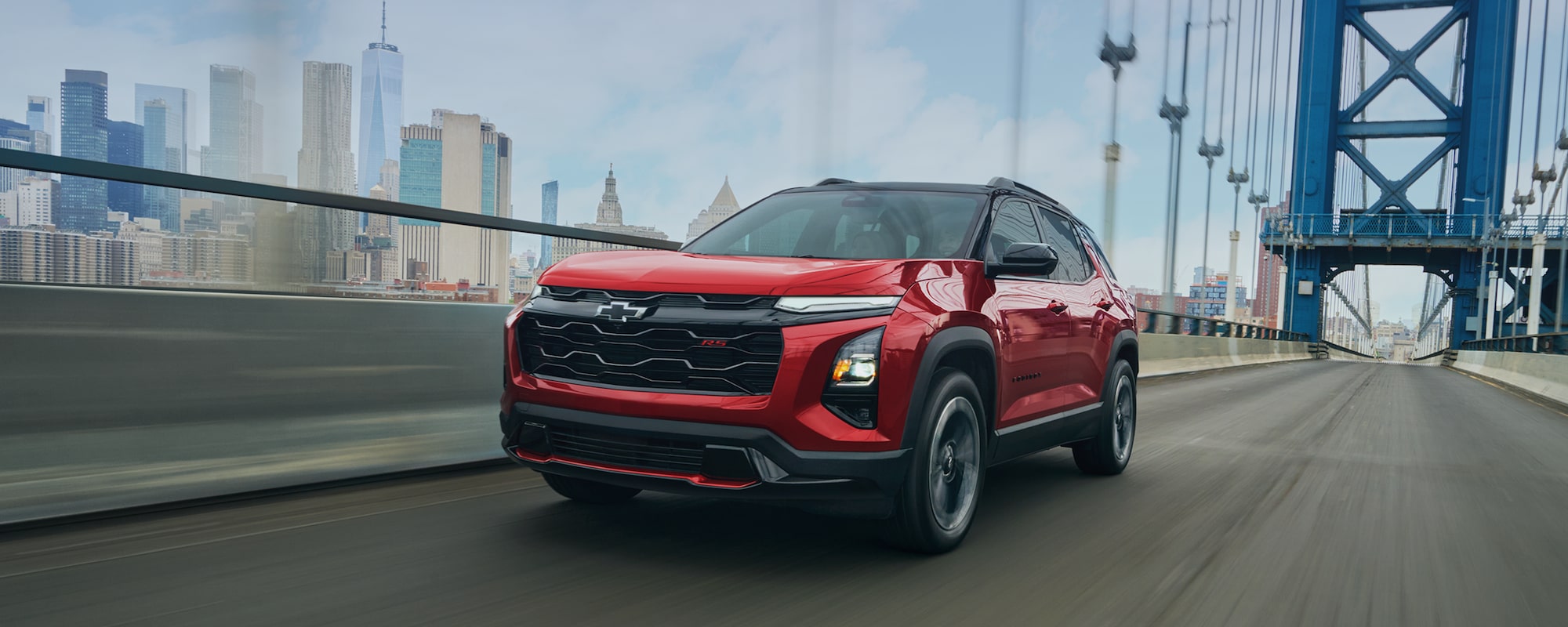 Illustrative: a red Chevrolet Equinox compact SUV crossing a bridge with a city skyline behind it