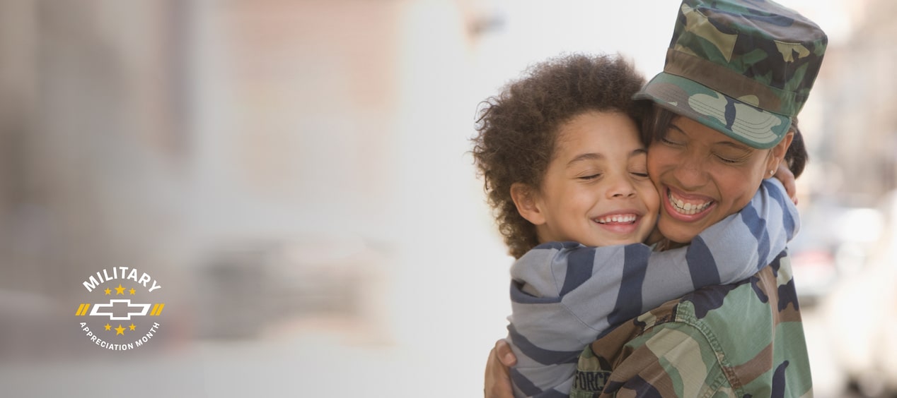 Close-up of a Military Member Reuniting with a Child While Hugging and Smiling