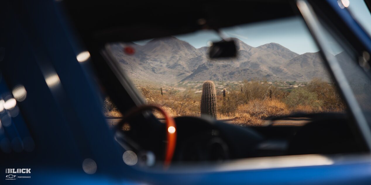 View of Mountains and Cacti Through the Windshield of a 1964 Corvette