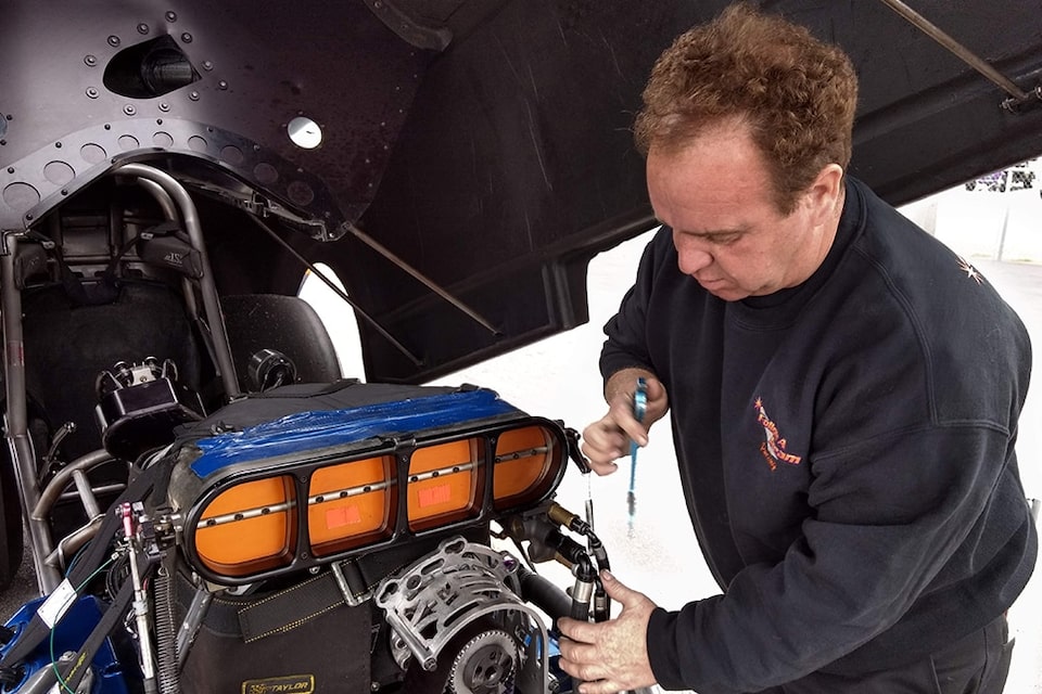 Blake works tirelesssly on his race car at the track and the shop.