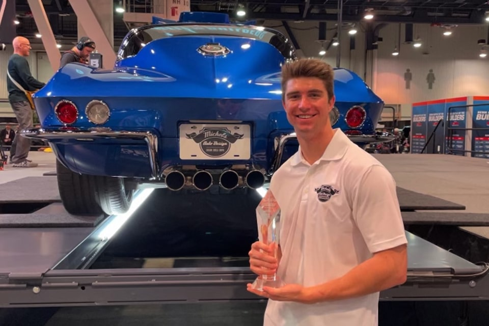Josh Michels of Michels Auto Design poses with his Battle of the Builders Young Guns winner's trophy during the 2022 SEMA Show.