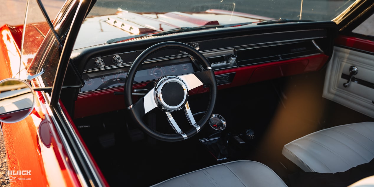 View of the Steering Wheel and Dashboard in a 1966 Chevrolet Chevelle SS Convertible Parked in an Empty Parking Lot