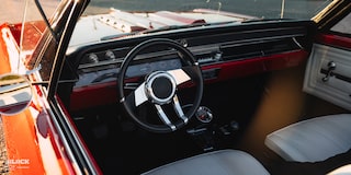 View of the Steering Wheel and Dashboard in a 1966 Chevrolet Chevelle SS Convertible Parked in an Empty Parking Lot