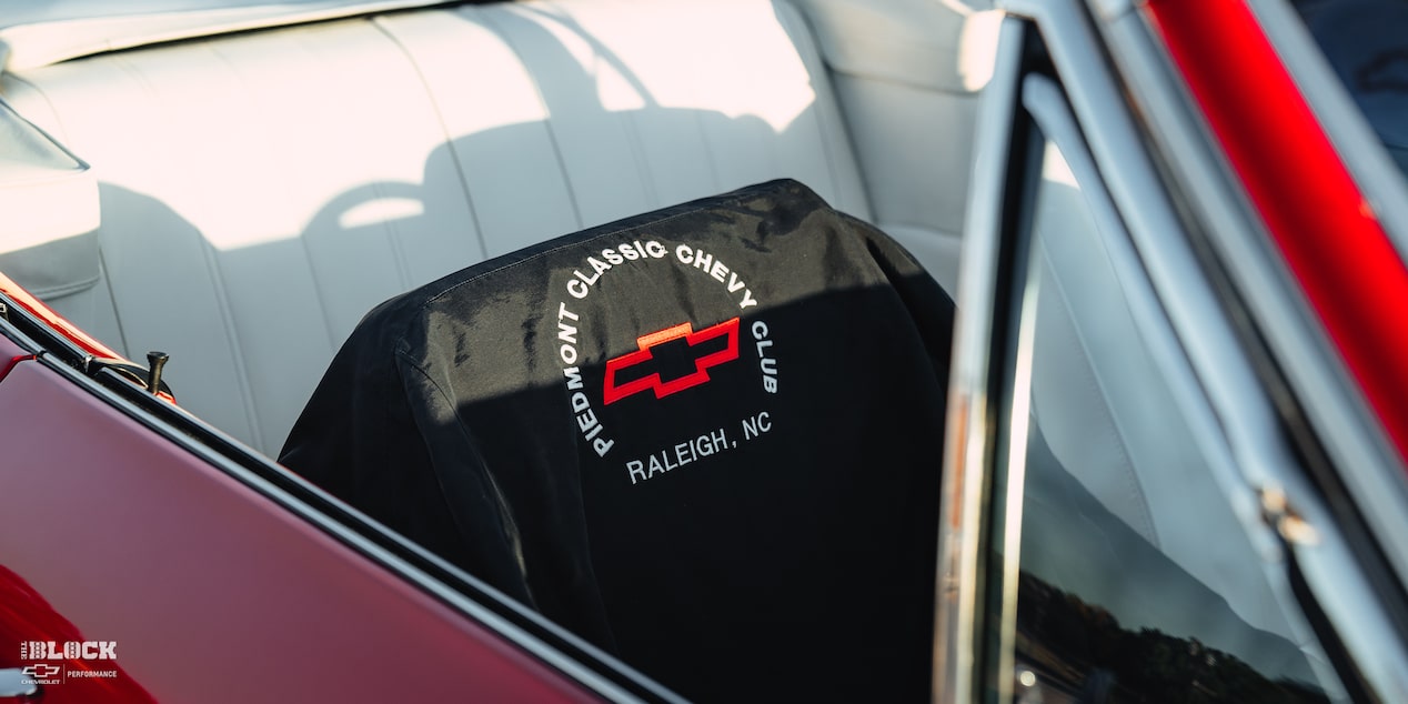 Close-up of "Piedmont Classic Chevy Club" Seat Cover in a 1966 Chevrolet Chevelle SS Convertible Parked in an Empty Parking Lot