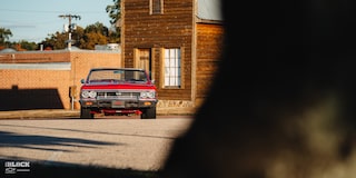 Partially Covered Wide Front View of a 1966 Chevrolet Chevelle SS Convertible Parked in an Empty Parking Lot