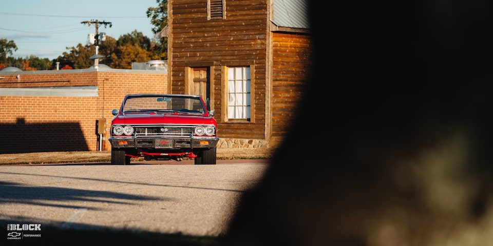 Partially Covered Wide Front View of a 1966 Chevrolet Chevelle SS Convertible Parked in an Empty Parking Lot