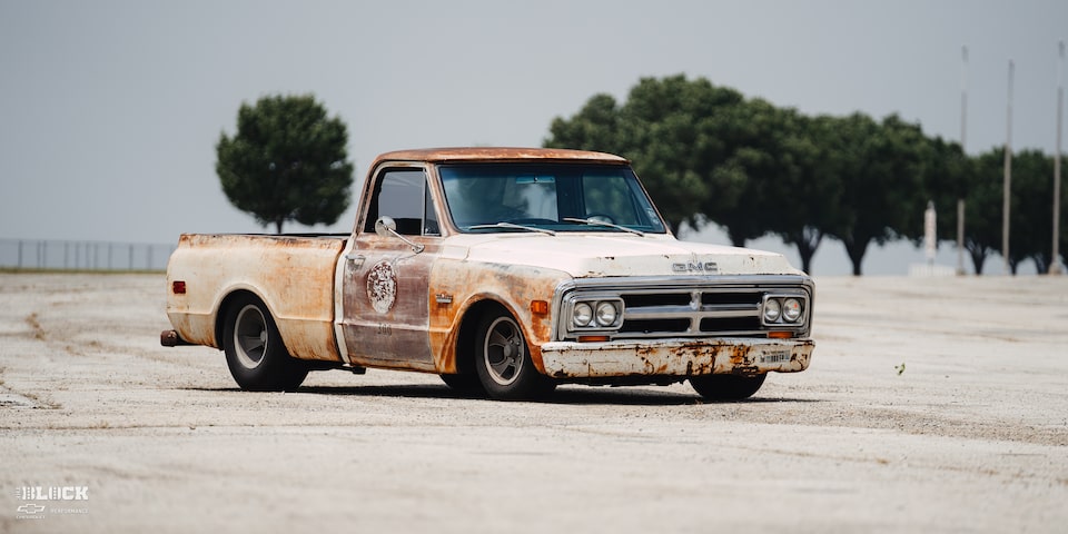 Front Side View of Dwight Ward’s 1971 GMC C15 Truck Parked In An Empty Lot
