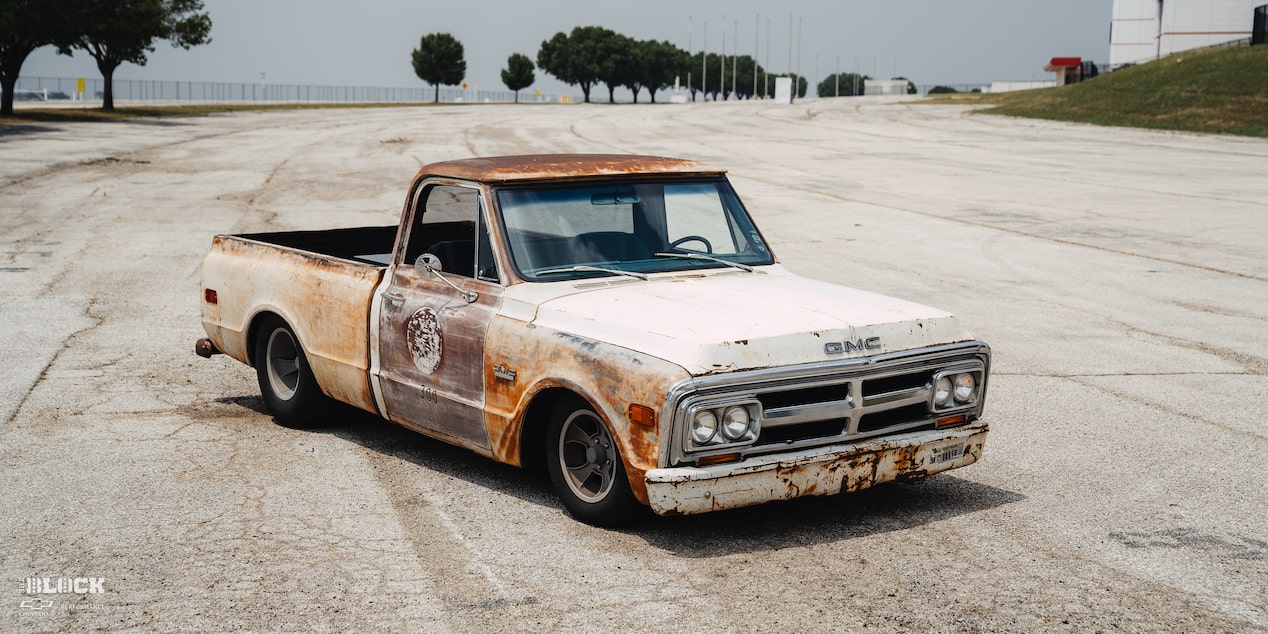 Close-Up Front Side View of Dwight Ward’s 1971 GMC C15 Truck Parked In An Empty Lot
