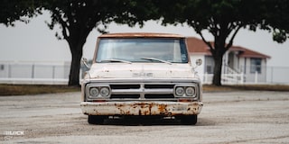 Front View of Dwight Ward’s 1971 GMC C15 Truck Parked In An Empty Lot