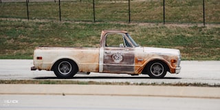 Side View of Dwight Ward’s 1971 GMC C15 Truck Parked In An Empty Lot