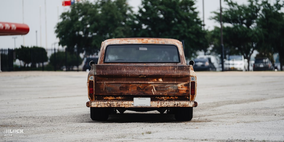 Back View of Dwight Ward’s 1971 GMC C15 Truck Parked In An Empty Lot