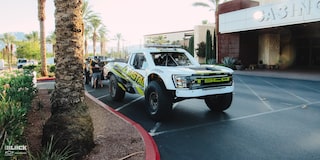 Front Side View of an Off-Road Chevy Truck Parked Next to a Curb