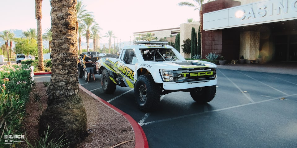 Front Side View of an Off-Road Chevy Truck Parked Next to a Curb