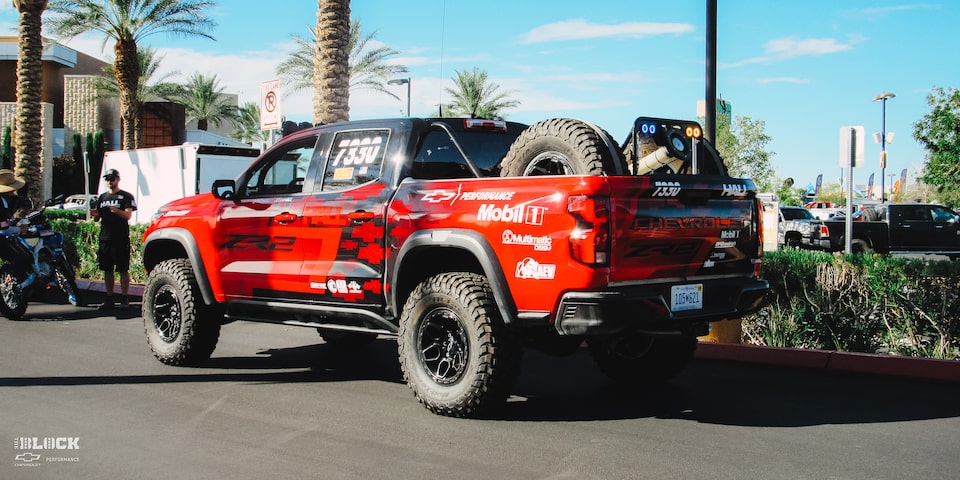 Rear Side View of a Off-Roading Chevy ZR2 Truck With the Driver Inside