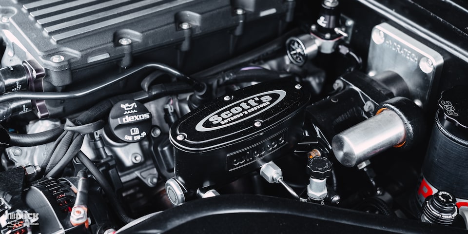 Close-up of the Scott's Hotrods 'n Customs Logo on the Engine in a 1970 Chevy K5 Blazer