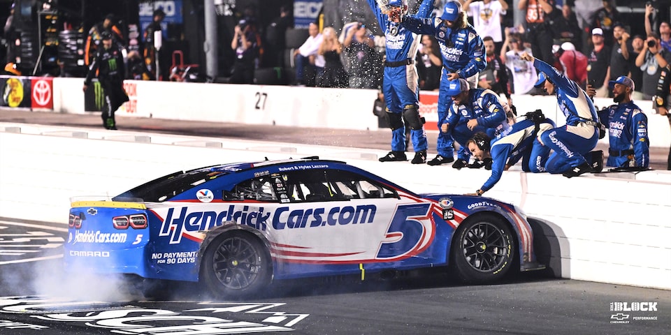 Larson celebrates with his Hendrick Motorsports crew on the Darlington frontstretch.