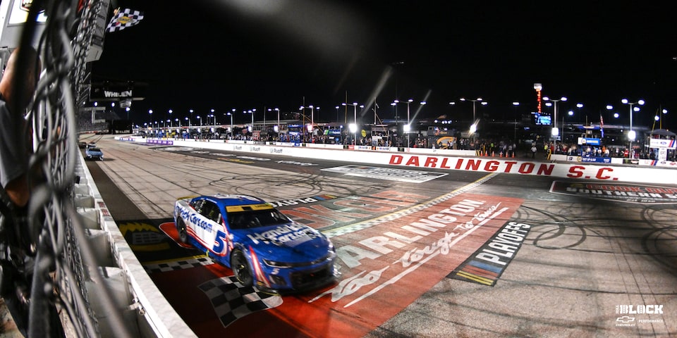 Team Chevy Driver Kyle Larson Crossing the Finish Line on a Race Track