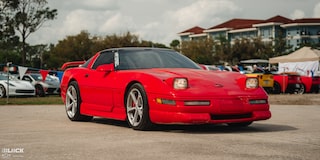 Front View of Mitch Dixon's Red Greenwood Corvette Parked in Front of Sports Cars