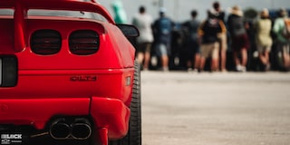 Close-up of the Right Rear of Mitch Dixon's Red 1996 Greenwood Corvette Parked in Front of a Crowd