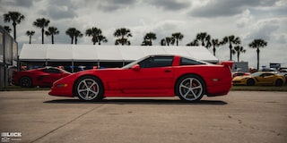 Side View of a Parked Red 1996 Greenwood Corvette at a Race Track