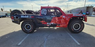 Side View of Hall Racing's Red Chevrolet Truck Parked at the BF Goodrich Tires Mint 400