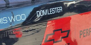 Close-up View of Hall Racing's Unlimted Truck Decal Reading "Dom Lester"