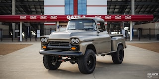 Three Quarters View of a Silver 1958 Chevy Apache Pickup Truck in Front of the Stadium Gate