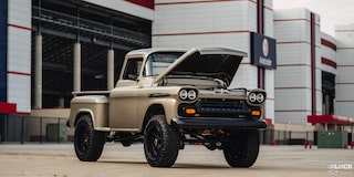Three Quarters View of a 1958 Chevy Apache Pickup Truck with Its Hood Open in Front of a Building