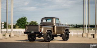 A Three Quarters Rear View of a 1958 Silver Chevy Apache Pickup Truck Under a Clear Blue Sky