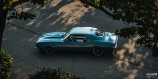 Overhead Shot of a 1968 Blue Chevy Camaro Under the Shade on a Road
