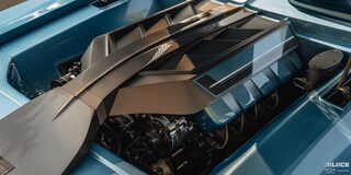 Close-up of the Engine of a 1968 Blue Chevy Camaro Under Shade