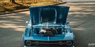 Front Eye-Level View of a 1968 Blue Chevy Camaro with Its Hood Open on an Empty Road
