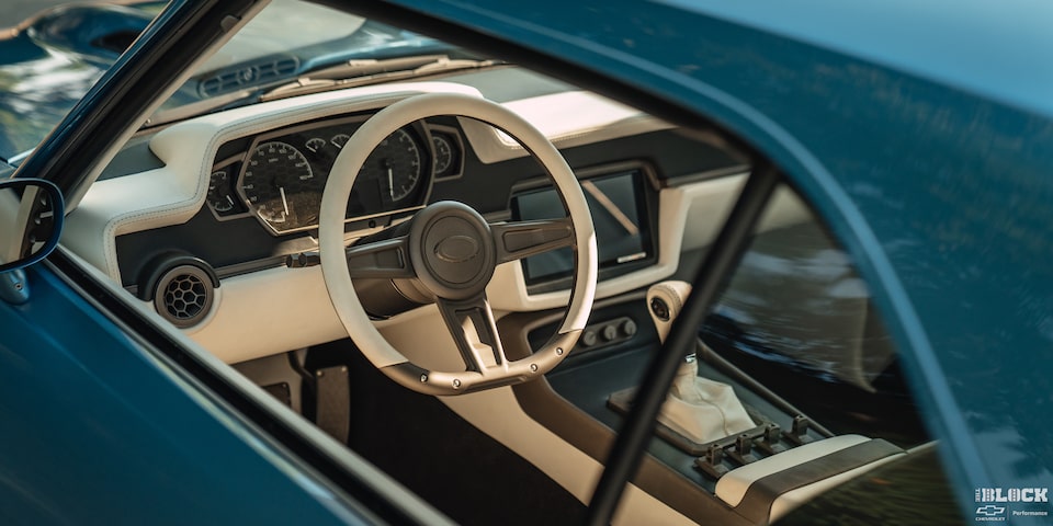 The car’s white interior contrasts well with the eye-catching light-blue paint.