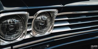 Close-up of the Headlight and Grille of A Black 1969 Chevy Chevelle