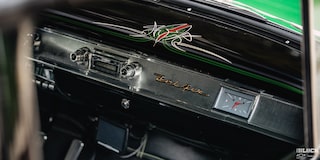 View of the Dashboard of a Synergy Green 1957 Chevrolet Sedan Delivery Through the Open Passenger Side Window