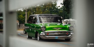 A View of a Synergy Green 1957 Chevrolet Sedan Delivery Through a Building Window