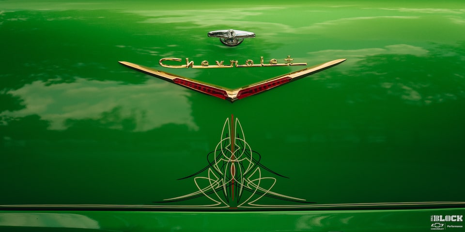 Close-up of a "Chevrolet" Emblem on a Synergy Green 1957 Chevrolet Sedan Delivery