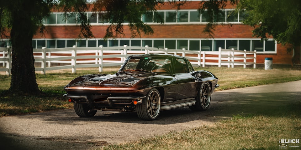 A 1963 Corvette Sting Ray Parked Under Shade in Front of a Building