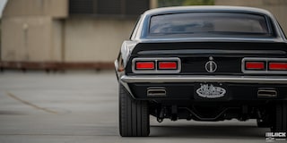 Rear View of a 1968 Black Chevy Camaro Placed at the Edge of the Frame