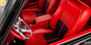Red Interior Seats Seen through the Front Left Window of a 1968 Chevy Camaro