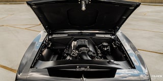 Close-up Front View of a Black 1968 Chevy Camaro with its Hood Open and Engine Exposed