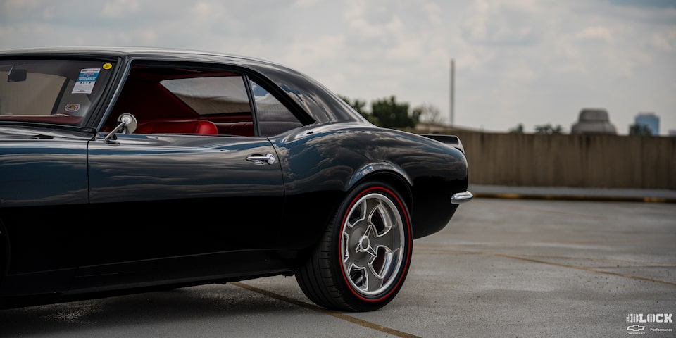 Side View of a Black 1968 Chevy Camaro Left Rear Door in an Empty Parking Lot