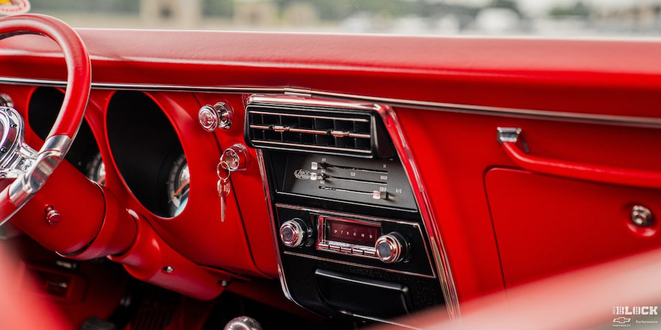 View of the Red Steering Wheel and Dashboard in a 1968 Chevy Camaro