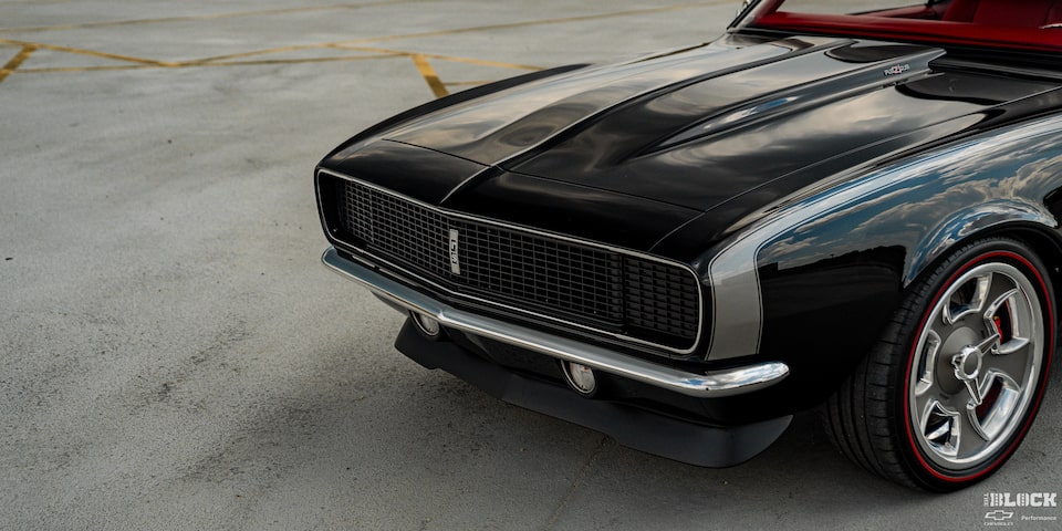 Closed Front Hood of a 1968 Black Chevy Camaro in an Empty Parking Lot