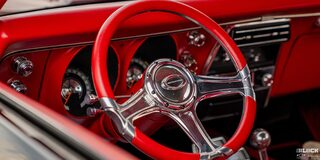 Close-up of Red Steering Wheel and Interior Viewed from the Outside the Left Window of a Chevy 1968 Camaro