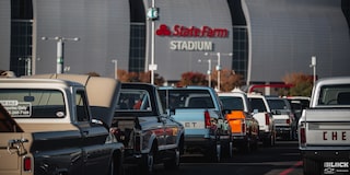 Three Quarters View of a Line of Cars on the Road Next to the State Farm Stadium