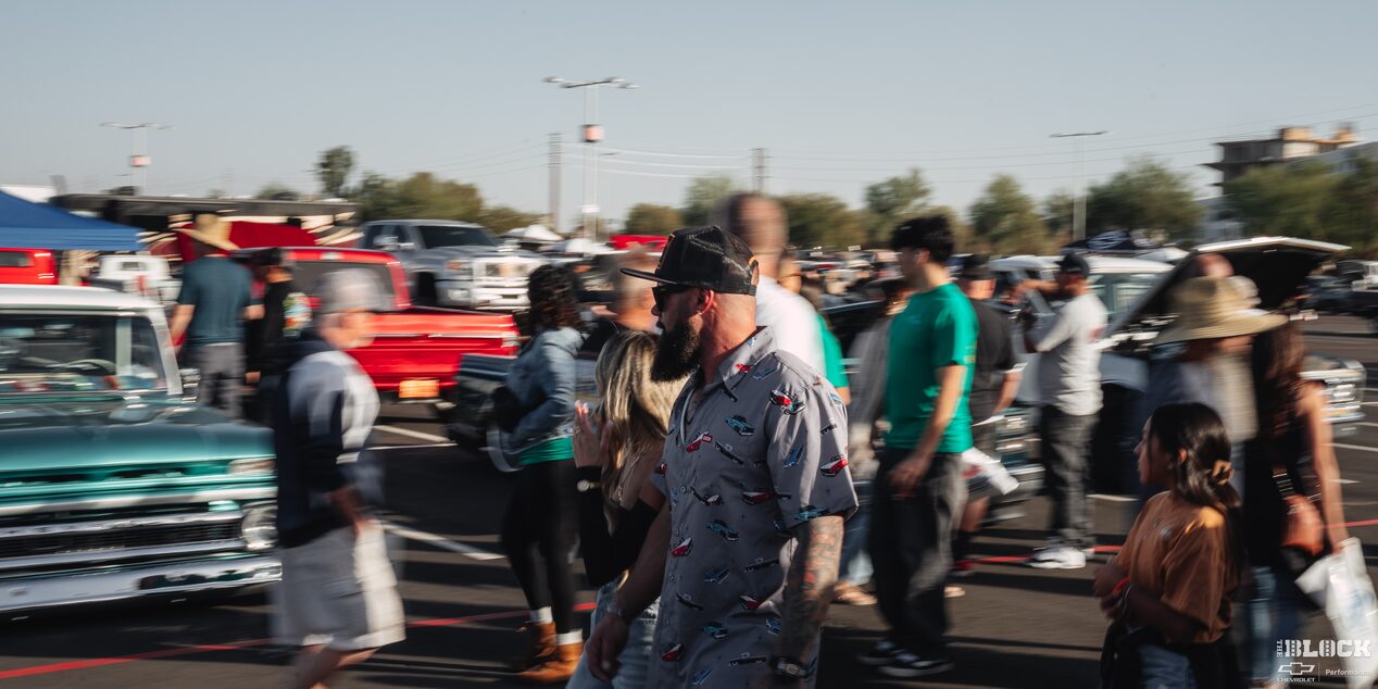 A Man in Focus Looking at the Distance with a Crowed of People Walking at Dino’s Git Down Event