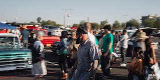 A Man in Focus Looking at the Distance with a Crowed of People Walking at Dino’s Git Down Event